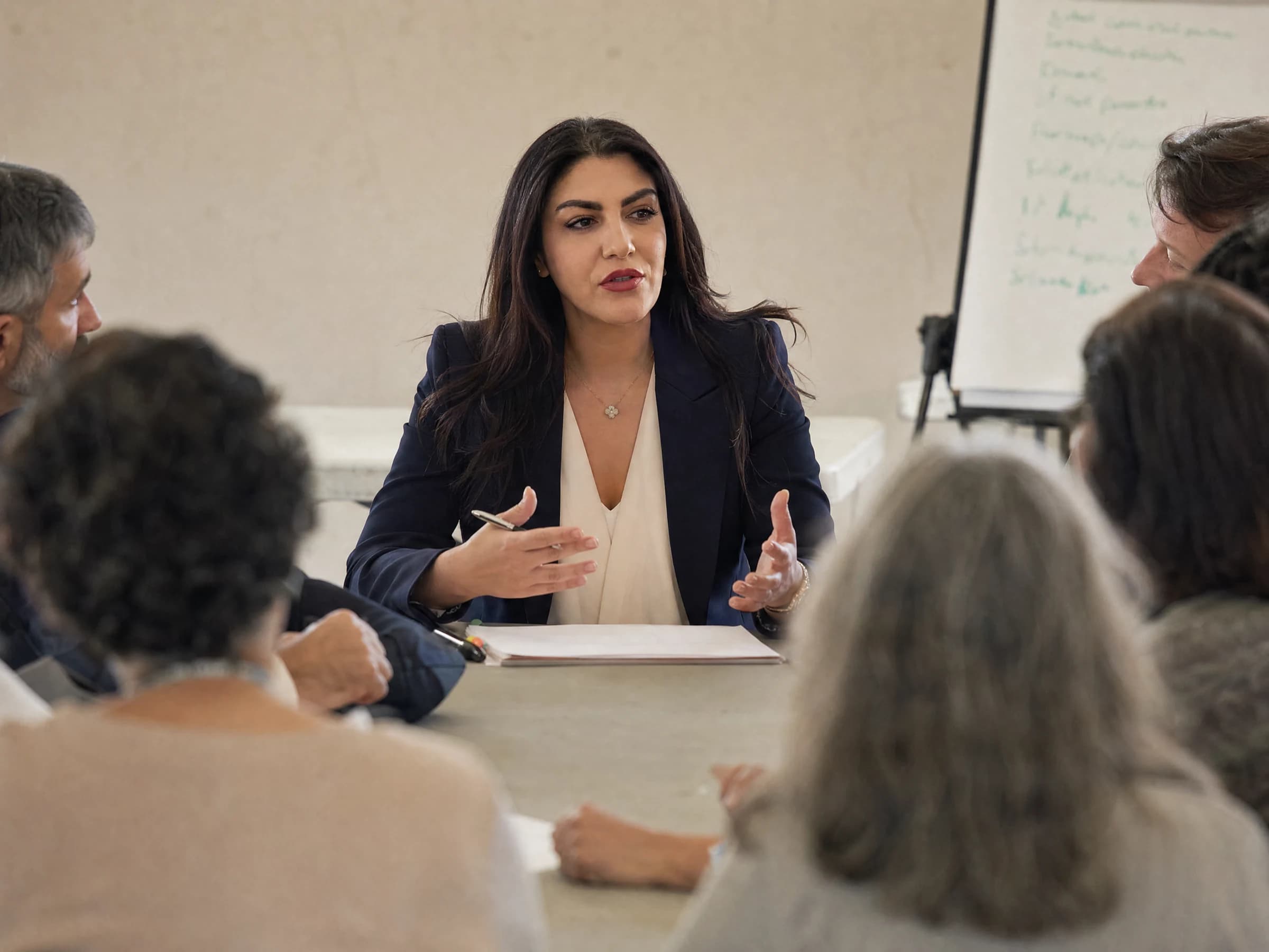 Nonprofit leadership — a small board meeting in a community room with a flip-chart agenda, Canada