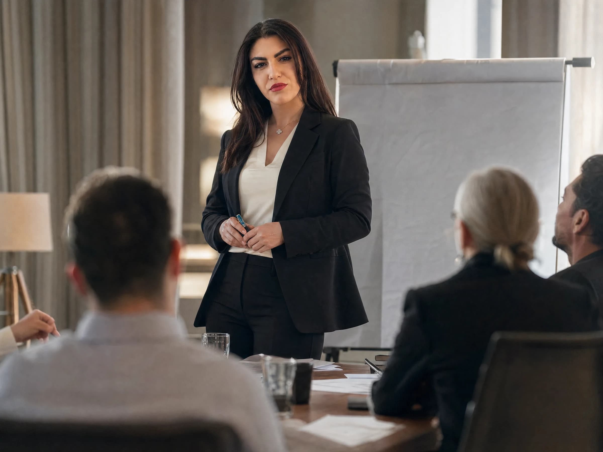 Leadership development — a small group of managers working through a case exercise at a long table, Canada